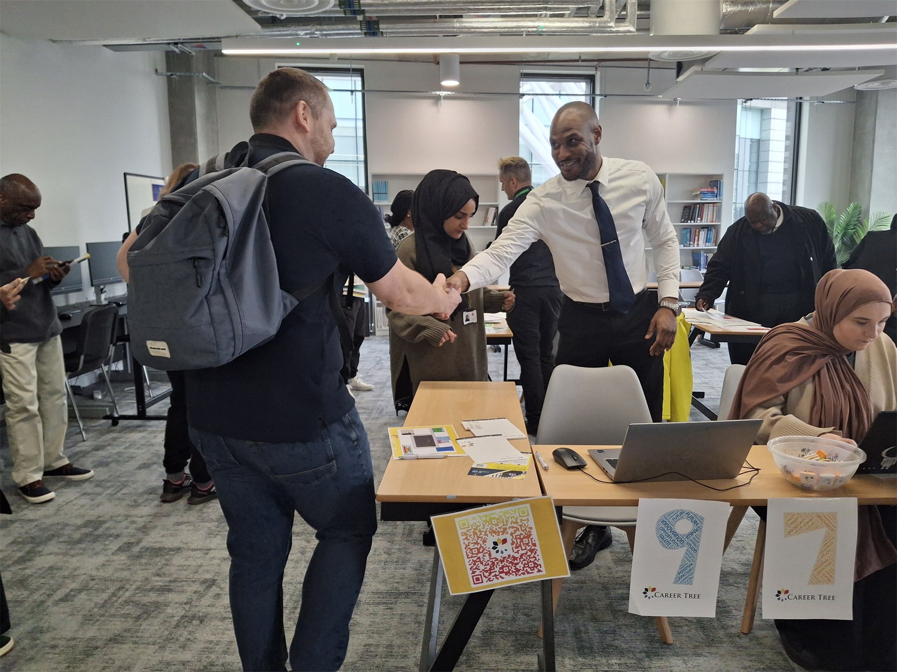 An attendee and exhibitor greeting each other during an early Branching Out Connect event