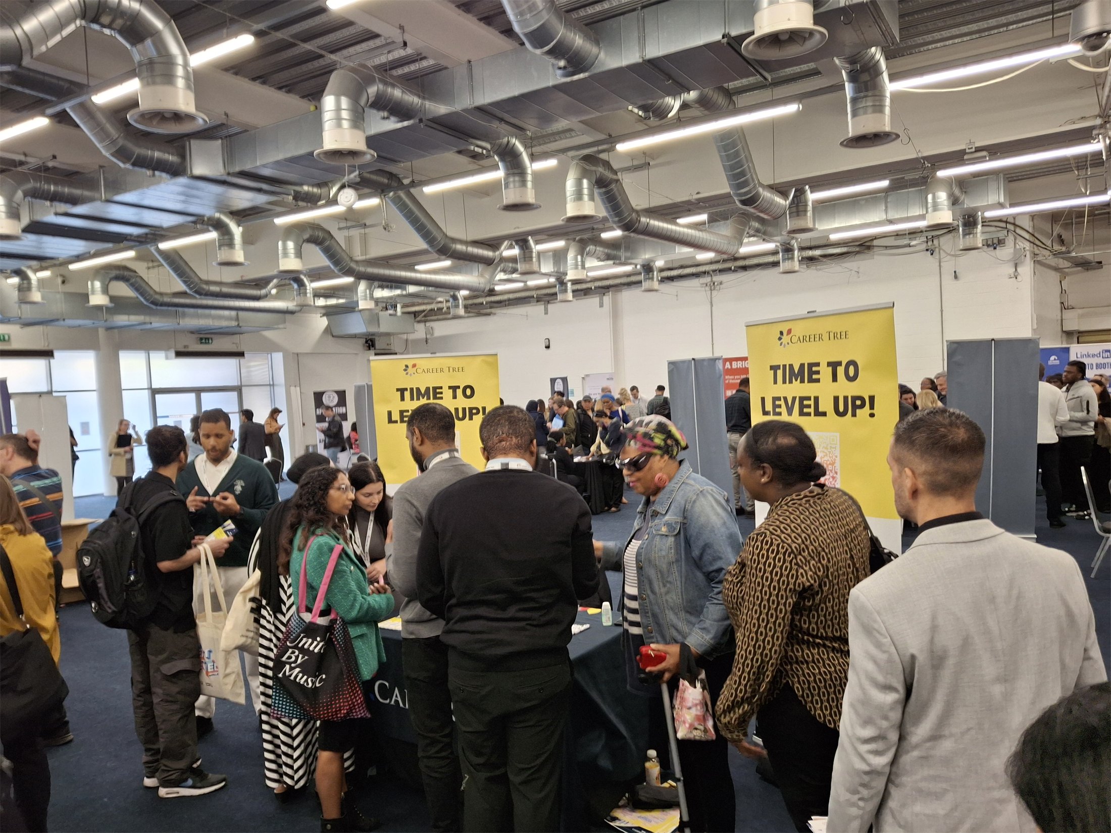 A busy CareerTree career fair with attendees speaking to exhibitors