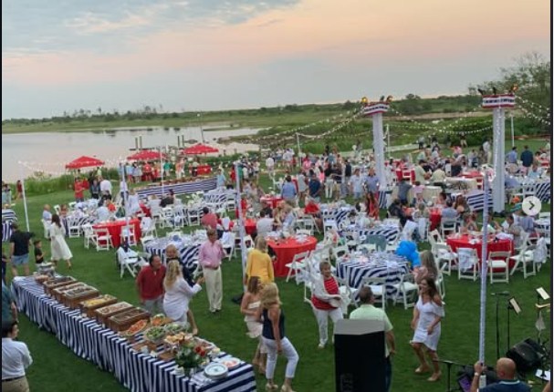 A large outdoor hospitality event beside the water at Ocean House Collection
